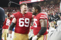 San Francisco 49ers offensive tackle Mike McGlinchey (69) comforts a tearful offensive guard Laken Tomlinson (75), who was overcome by emotion as the 49ers defeated the Green Bay Packers during the NFL NFC Championship football game, Sunday, Jan. 19, 2020 in Santa Clara, Calif. The 49ers defeated the Packers 37-20. (Margaret Bowles via AP)