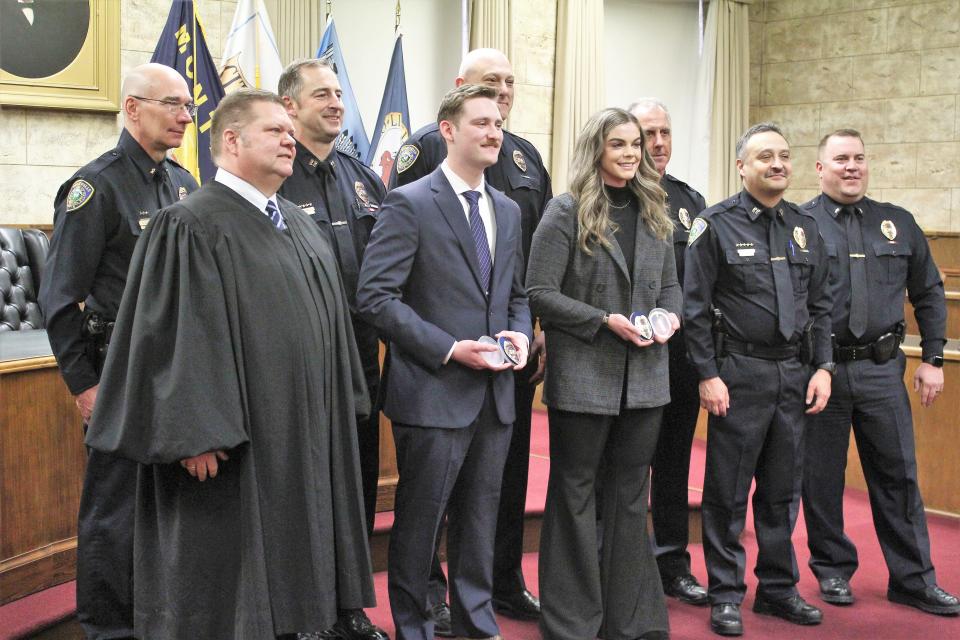 Great Falls' newest police officers, Peyton Mitchell and Alyssa Olson (center front) receive there badges during a ceremony on April 4. Despite the new hires the Great Falls Police Department remains 10 officers down from full staffing levels