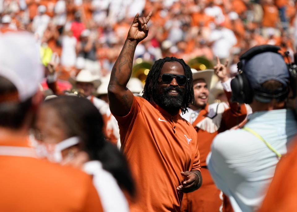 Former Texas running back Ricky Williams waves to the crowd during UT's 2021 ceremony naming the Royal-Memorial Stadium playing field after Earl Campbell and himself. Williams is one of only three players ever to win back-to-back Doak Walker Awards.