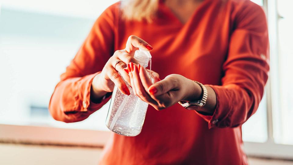 Women washing hands with alcohol gel or antibacterial soap sanitizer.