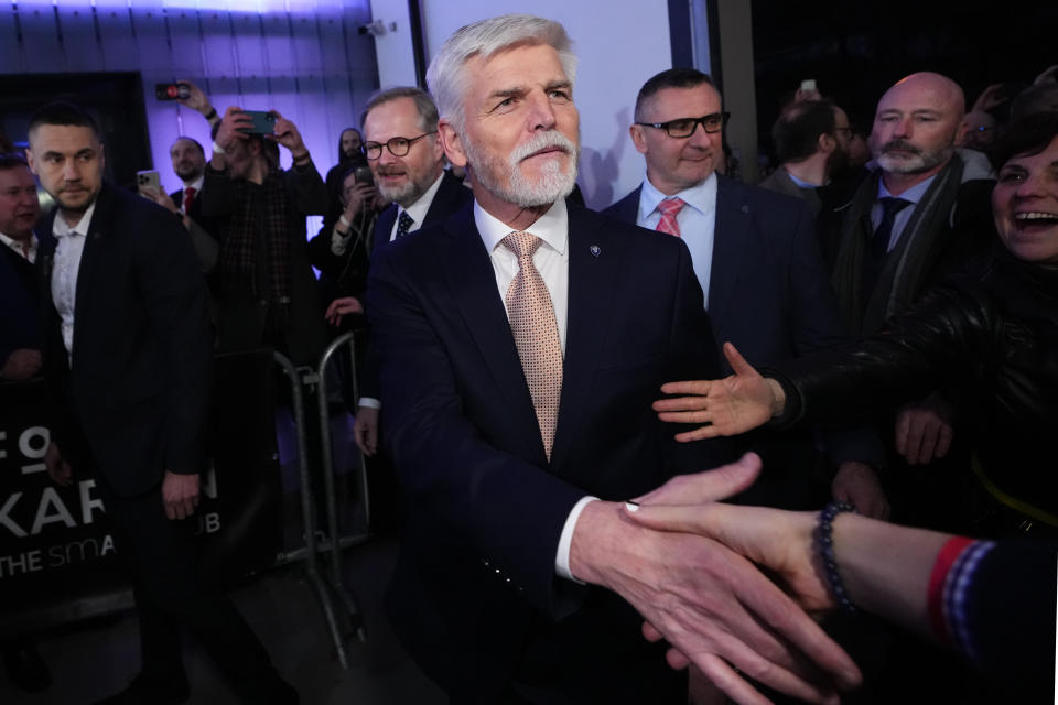 Czech Republic's President elect Petr Pavel shake hands with his supporter after announcement of the preliminary results of the presidential runoff in Prague, Czech Republic, Saturday, Jan. 28, 2023. (AP Photo/Petr David Josek)