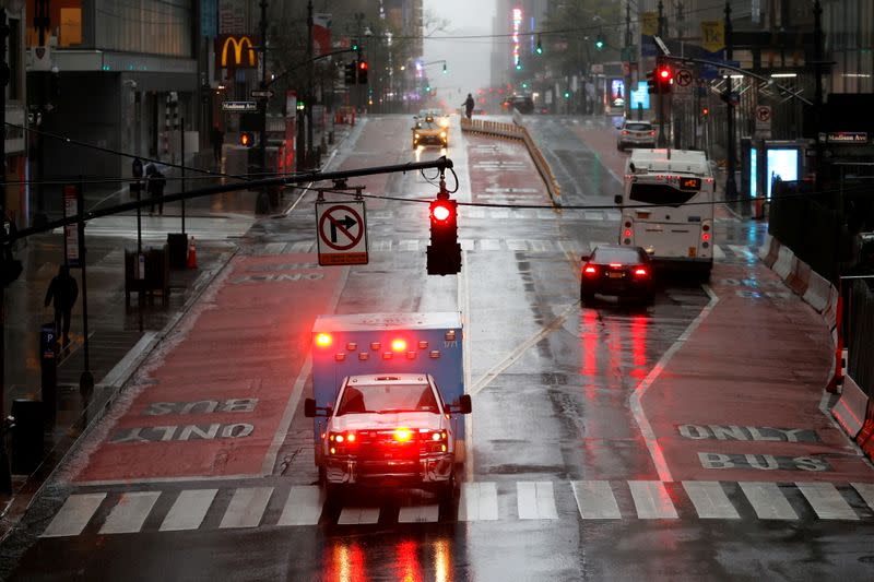 FILE PHOTO: Ambulance in heavy rain and high winds across nearly empty East 42nd street during outbreak of coronavirus disease (COVID-19) in New York