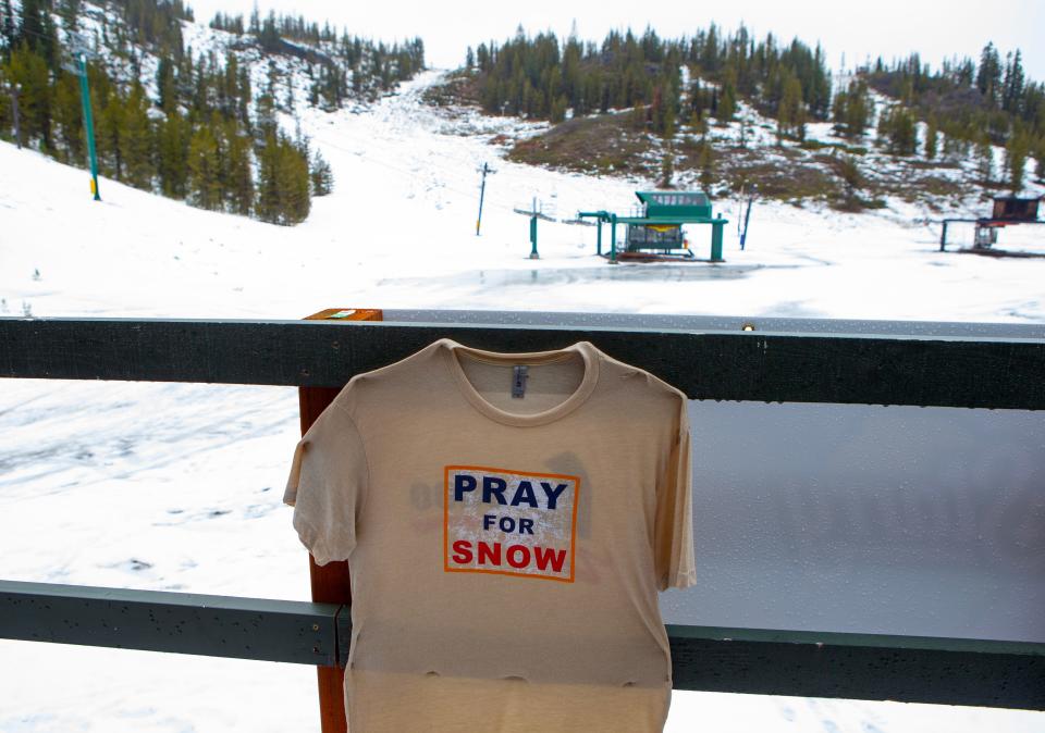 A T-shirt tacked to the rail of a Hoodoo Ski Area building asks for divine help to save the ski season.