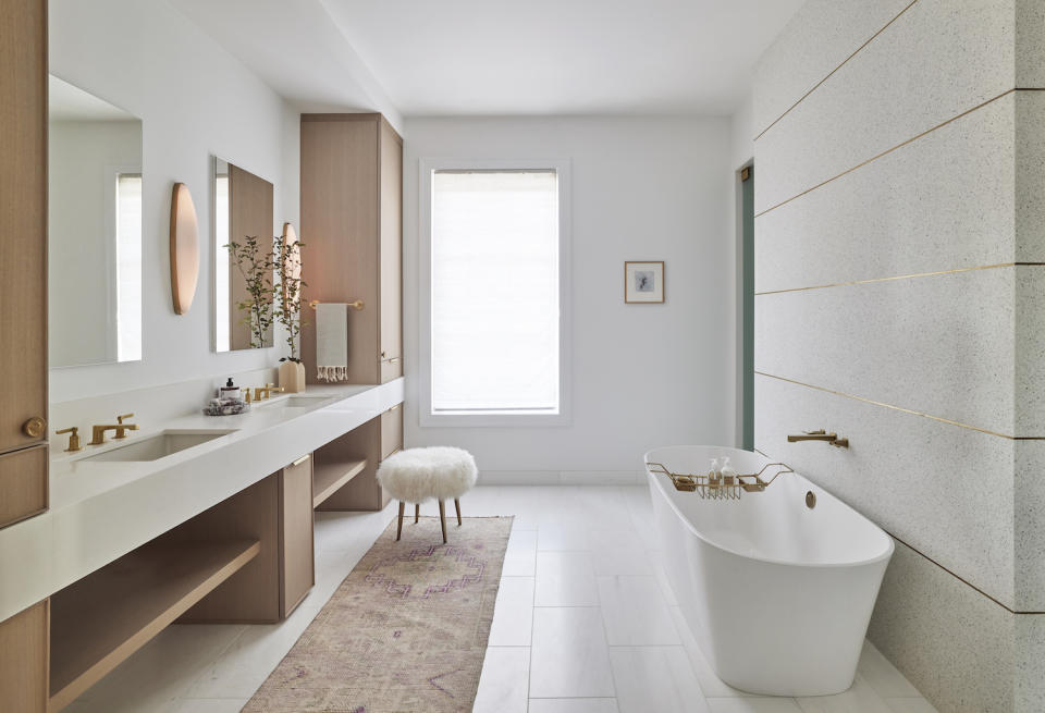 A beige bathroom with metallic accents