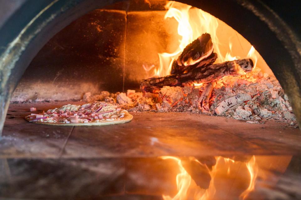 Feb 2, 2023; Tempe, AZ, United States; Inside of wood-fired  oven, a quesadilla bakes at Cocina Chiwas in Culdesac Tempe on Thursday. Feb. 2, 2023. Mandatory Credit: Alex Gould/The Republic