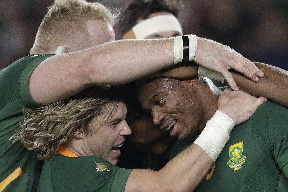 South Africa's Makazole Mapimpi, right, celebrates after scoring his side's first try during the Rugby World Cup final at International Yokohama Stadium between England and South Africa in Yokohama, Japan, Saturday, Nov. 2, 2019. (AP Photo/Mark Baker)