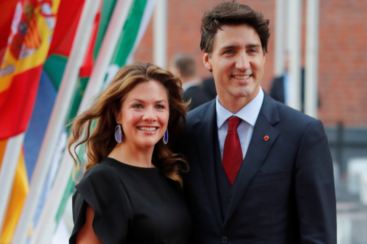 Sophie Grégoire Trudeau smiling, wearing black next to Prime Minister Justin Trudeau. (Image via Reuters)