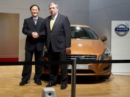 Chairman of Zhejiang Geely Holding Group Li Shufu (L) and former Executive Vice President and Chief Financial Officer of Ford Lewis Booth shake hands in front of a Volvo S60 car in the Volvo Hall at the Volvo plant and headquarters in Torslanda, Gothenburg in this March 28, 2010 file photo. Volvo Car Group plans to export a Chinese-made midsize sedan in 2015 to the United States, and is starting to weigh the possibility of building a vehicle factory in the United States, people familiar with the Chinese-owned automaker's plans said. To match story AUTOSHOW-VOLVO/ REUTERS/Bjorn Larsson Rosvall/Scanpix/Files (SWEDEN - Tags: TRANSPORT BUSINESS) SWEDEN OUT. NO COMMERCIAL OR EDITORIAL SALES IN SWEDEN