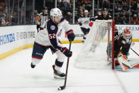 Columbus Blue Jackets' Emil Bemstrom (52) moves the puck as Anaheim Ducks goaltender Lukas Dostal (1) guards his net during the second period of an NHL hockey game Friday, March 17, 2023, in Anaheim, Calif. (AP Photo/Jae C. Hong)