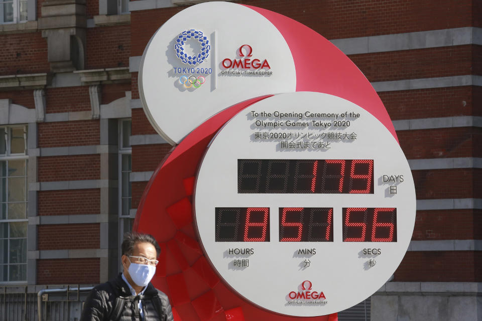 Image: A man walks past a Tokyo Olympic and Paralympic Games countdown clock at the Tokyo train station in Tokyo (Koji Sasahara / AP)