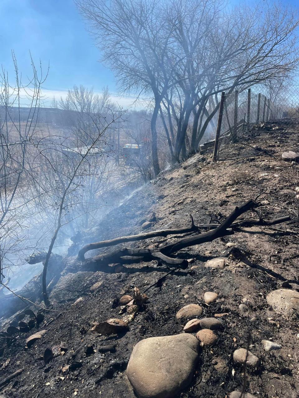 Smoke rises from a recently extinguished wildland blaze near County Road 3050 west of Aztec on Feb. 19.