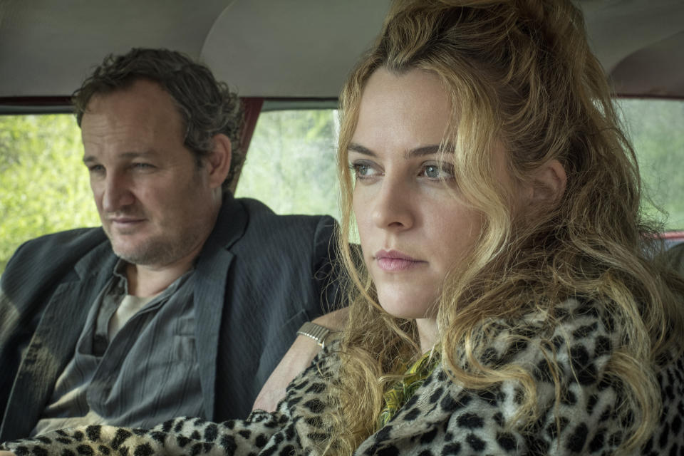 This image released by Netflix shows Jason Clarke, left, and Riley Keough in a scene from "The Devil All The Time." (Glen Wilson/Netflix via AP)