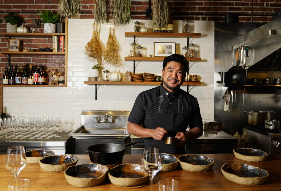 Chef Aaron Verzosa poses for a portrait while demonstrating plating Tailor Made, a course in which diners disclose their hunger level from five to one, at Filipino American restaurant Archipelago, Wednesday, May 24, 2023, in Seattle. Verzosa is nominated for a 2023 James Beard Award in the Best Chef: Northwest and Pacific category. (AP Photo/Lindsey Wasson)