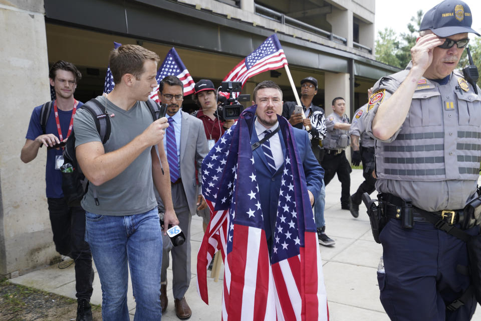 White nationalist Jason Kessler arrives at the Vienna metro station in Vienna, Va., Sunday, Aug. 12, 2018. White nationalists are gathering there to travel to Washington on the first anniversary of their rally in Charlottesville. (AP Photo/Sait Serkan Gurbuz)