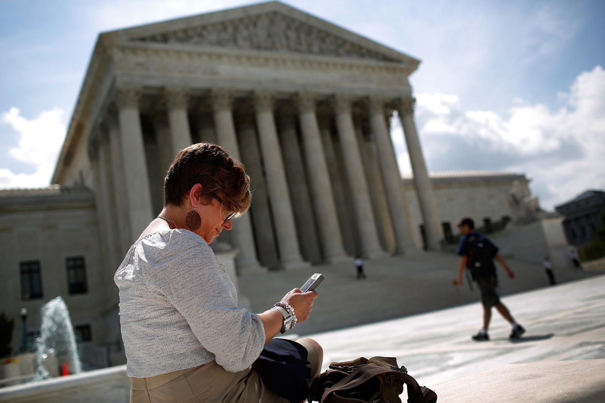  Woman on phone outside of Supreme Court building. 