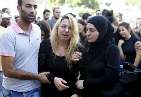 Relatives of the Safwan family mourn upon the arrival of seven bodies from their family at the Beirut international airport, Lebanon October 21, 2015. REUTERS/Mohamed Azakir