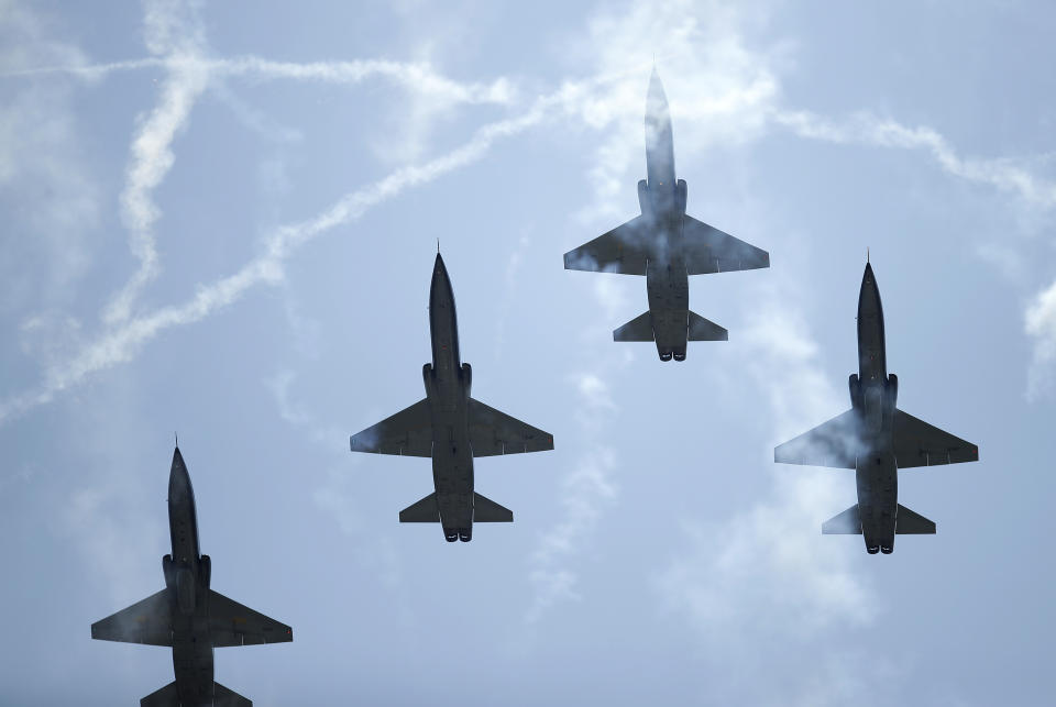 Jets fly through smoke from fireworks prior to a baseball game between the Atlanta Braves and Miami Marlins on Sunday, July 4, 2021, in Atlanta. (AP Photo/Ben Margot)