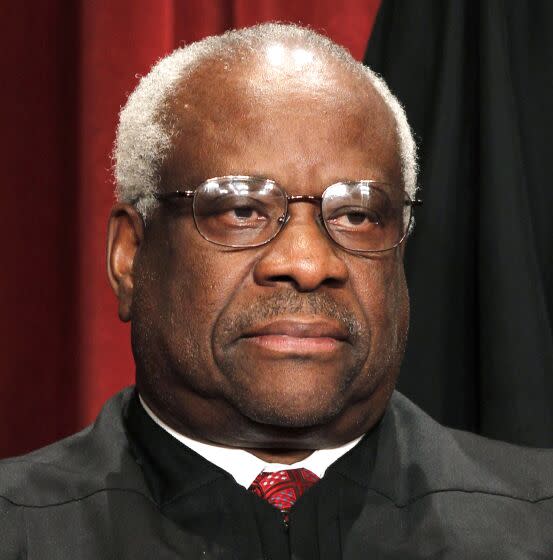 FILE - In this Oct. 8, 2010 file photo, Associate Justice Clarence Thomas is seen during the group portrait at the Supreme Court Building in Washington. Liberals and Democrats in Congress want Justice Thomas off the health care case. Conservative interest groups and Republican lawmakers say it's Justice Elena Kagan who should sit it out. Neither justice is budging — the right decision, according to many ethicists and legal experts. (AP Photo/Pablo Martinez Monsivais, file)