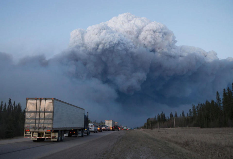 Drivers wait for clearance to take firefighting supplies into town on May 05, 2016 outside of Fort McMurray, Alberta. (Photo by Scott Olson/Getty Images)