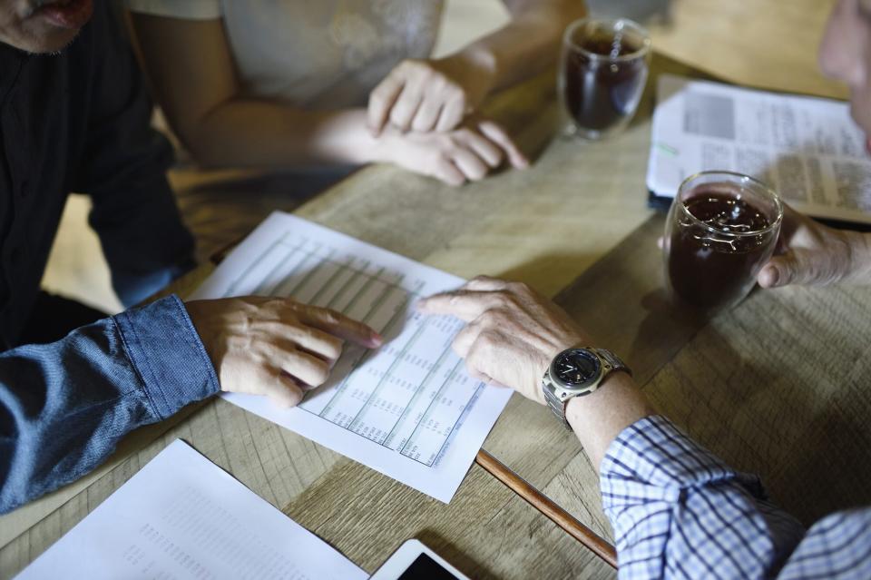 An image of people looking at medical paperwork.