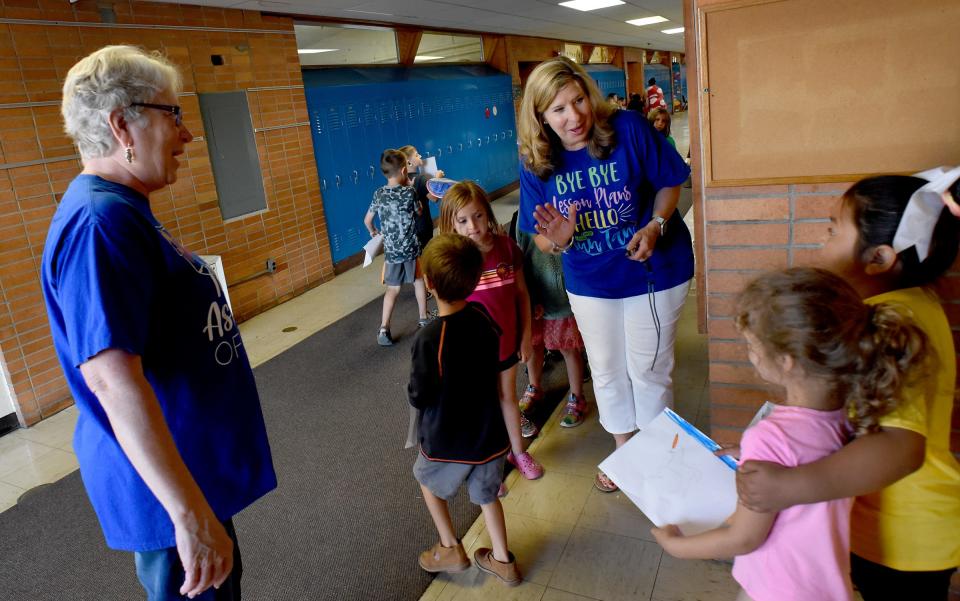 Ida Elementary kindergarten teacher Sherry Locke (right) and teaching assistant Carolyn Clark (left) watch as the students change classes as different activities were planned in the kindergarten and young fives classrooms on the last day of school.