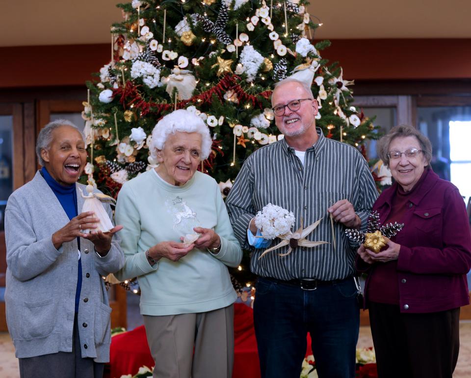 Sister Mary Jerome Lacy, from left, Sister Rosalynn Dzikonski, environmental coordinator Larry Willkomm and Sister Margaret Klotz were among those who made ornaments from items grown on the grounds of the sisters' convent.