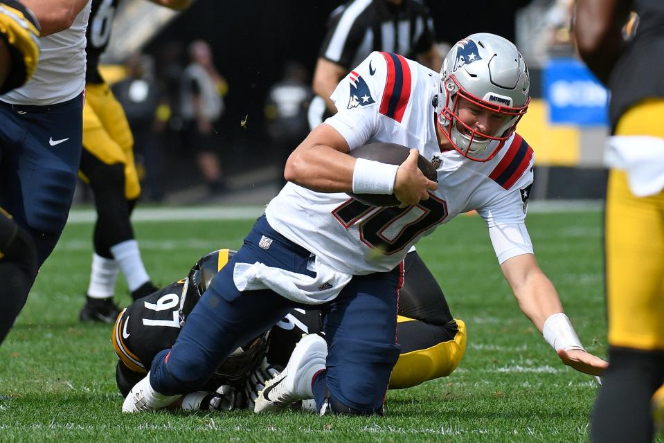 Patriots quarterback Mac Jones (10) is tackled by Steelers defensive tackle Cameron Heyward after a short gain during the first half of Sunday's game.