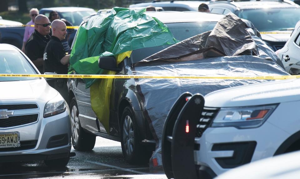 Authorities investigate the the death of a child found inside a vehicle in the parking lot of the PATCO Lindenwold Station on Friday, August 16, 2019.