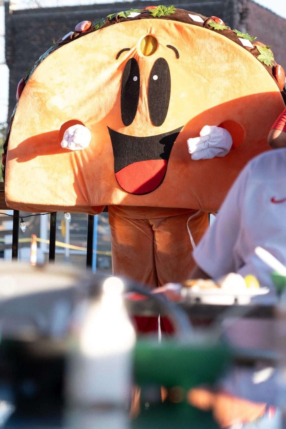 The KCK Taco Trail mascot greets guests on the patio of El Torrito Grill on Wednesday in Kansas City, Kansas.