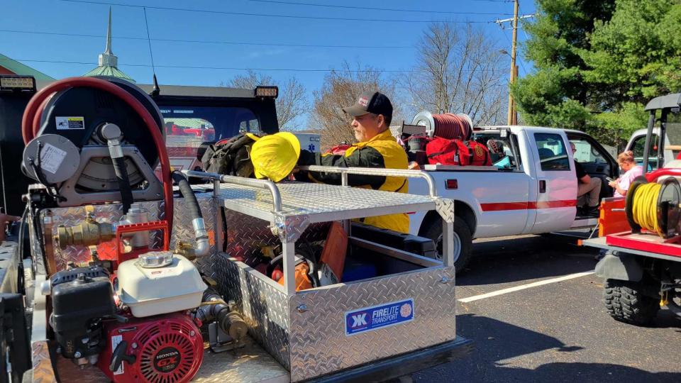 A firefighter from Etowah Horse Shoe Fire & Rescue gets his gear ready to go help with the Poplar Drive Fire on Nov. 6.