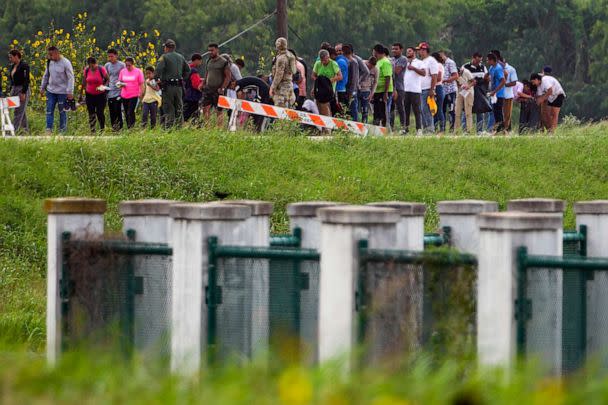 PHOTO: FILE - Migrants talk to officials along a road near the Rio Grande after crossing the Texas-Mexico border, May 11, 2023, in Brownsville, Texas. (Julio Cortez/AP, FILE)