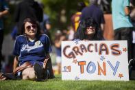 Carmen Lucatero, 47, and Rocio Hodges, 51, hold a sign at a makeshift memorial to former San Diego Padres outfielder Tony Gwynn at Petco Park in San Diego, California June 16, 2014. Gwynn, one of the greatest hitters of his generation, died on Monday at age 54 after a battle with cancer, the National Baseball Hall of Fame and Museum said. REUTERS/Sam Hodgson (UNITED STATES - Tags: SPORT BASEBALL OBITUARY)