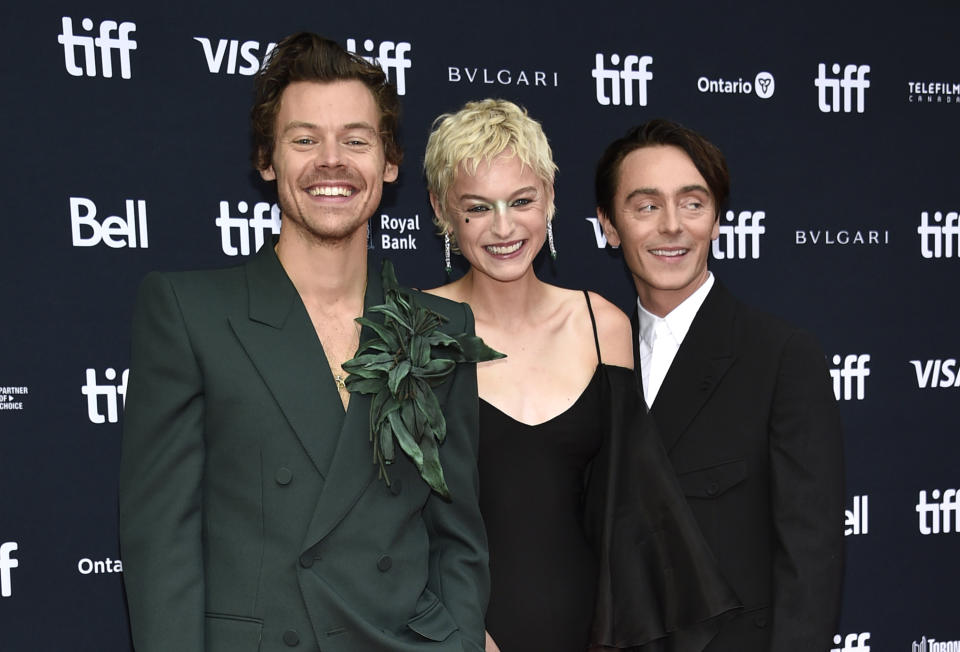 Harry Styles, from left, Emma Corrin, and David Dawson attend the premiere of 