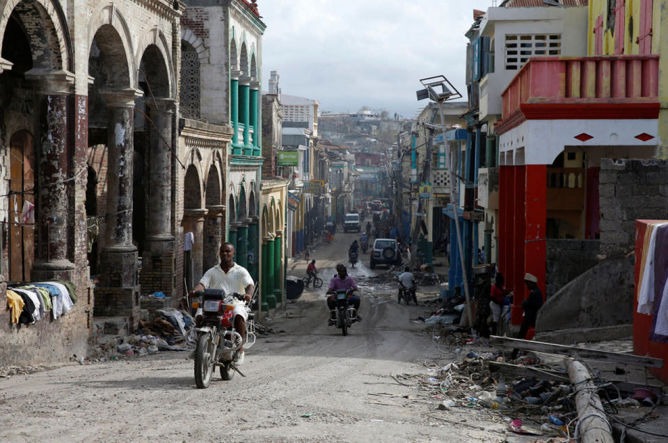 <p>People ride motorcycles on a street after Hurricane Matthew passes in Jeremie, Haiti, October 9, 2016. (Carlos Garcia Rawlins/Reuters)</p>