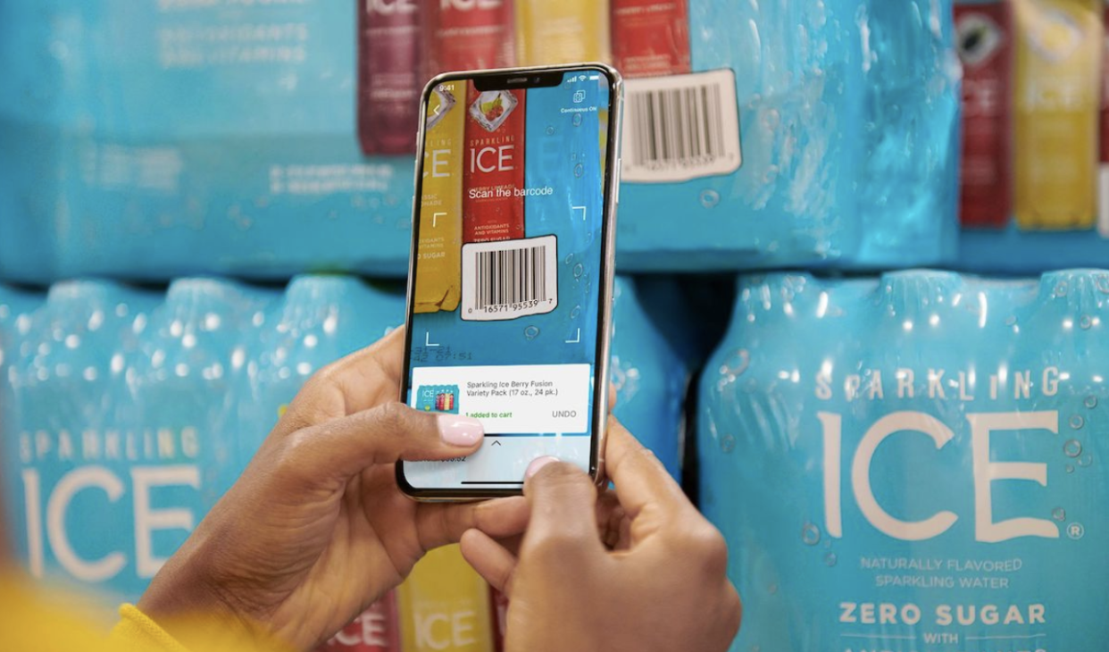 A person using their smart phone to shop and check out at Sam's Club