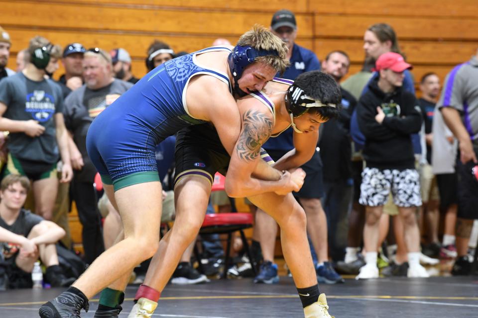 McKeel's Deacon Warren (152), left, competes in regions versus Hernando's Brandon Ruiz. Warren won in a tiebreaker, 4-3 versus Ruiz and would go on to advance to Day 2.