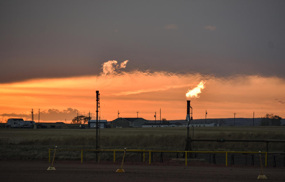 FILE - Flares burn natural gas from oil production in the Fort Berthold Indian Reservation east of New Town, North Dakota, May 18, 2021. The Interior Department on Monday, Nov. 28, 2022, proposed rules to limit methane leaks from oil and gas drilling on public lands, the latest action by the Biden administration to crack down on emissions of methane, a potent greenhouse gas that contributes significantly to global warming. (AP Photo/Matthew Brown, File)