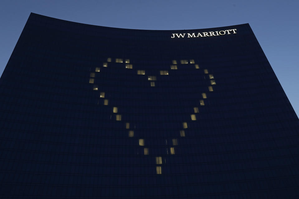 File-This April 7, 2020, file photo shows a heart shining on the side of the JW Marriott, in Indianapolis. Businesses are rethinking political contributions in the wake of the deadly Capitol siege by President Donald Trump’s supporters on Wednesday, Jan. 6, 2021. Citigroup confirmed Sunday, Jan. 10, 2021, that it is pausing all federal political donations for the first three months of the year. Others, like Marriott, are only stopping donations to the 147 Republicans who opposed certifying President-elect Joe Biden’s election. (AP Photo/Darron Cummings, File)