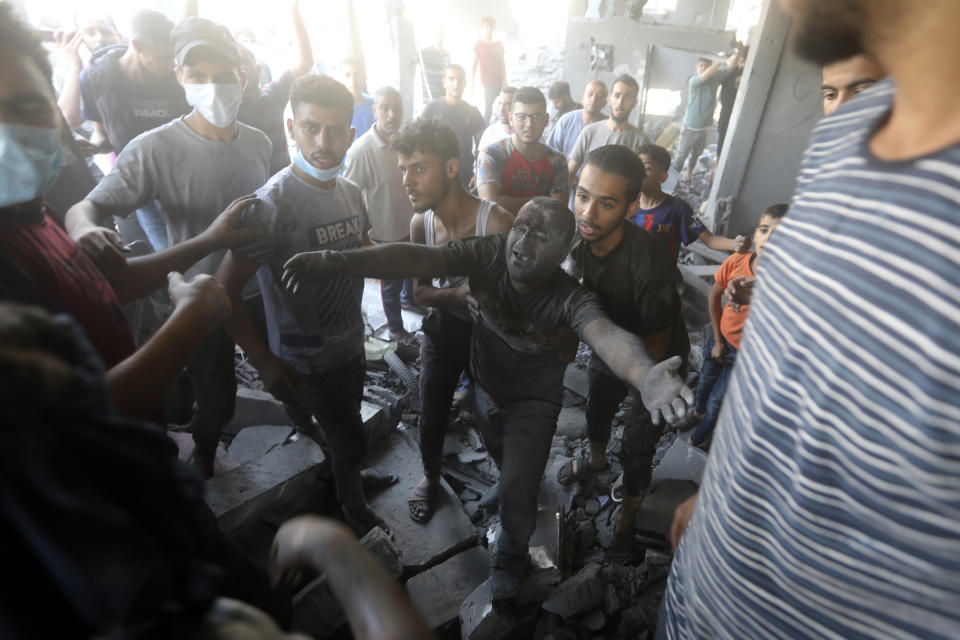 A Palestinian man reacts after being rescued from under the rubble of a destroyed building following an Israeli airstrike in Bureij refugee camp, Gaza Strip, Thursday, Nov. 2, 2023. (AP Photo/Mohammed Dahman)