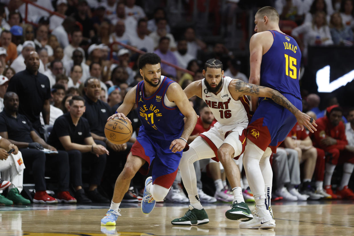 MIAMI, FLORIDA - JUNE 07: Jamal Murray #27 of the Denver Nuggets dribbles past a screen set by Nikola Jokic #15 against Caleb Martin #16 of the Miami Heat during the fourth quarter in Game Three of the 2023 NBA Finals at Kaseya Center on June 07, 2023 in Miami, Florida. NOTE TO USER: User expressly acknowledges and agrees that, by downloading and or using this photograph, User is consenting to the terms and conditions of the Getty Images License Agreement. (Photo by Mike Ehrmann/Getty Images)