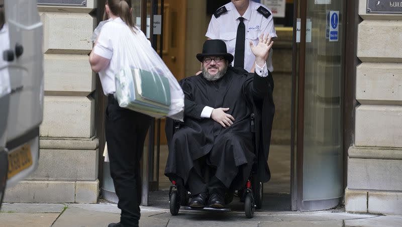 Nicholas Rossi waves as he leaves the Edinburgh Sheriff and Justice of the Peace Court in Edinburgh, Scotland, Wednesday, July 12, 2023. An American fugitive accused of faking his own death to avoid a rape charge, Rossi has been ordered by a judge in Scotland to be returned to the U.S.