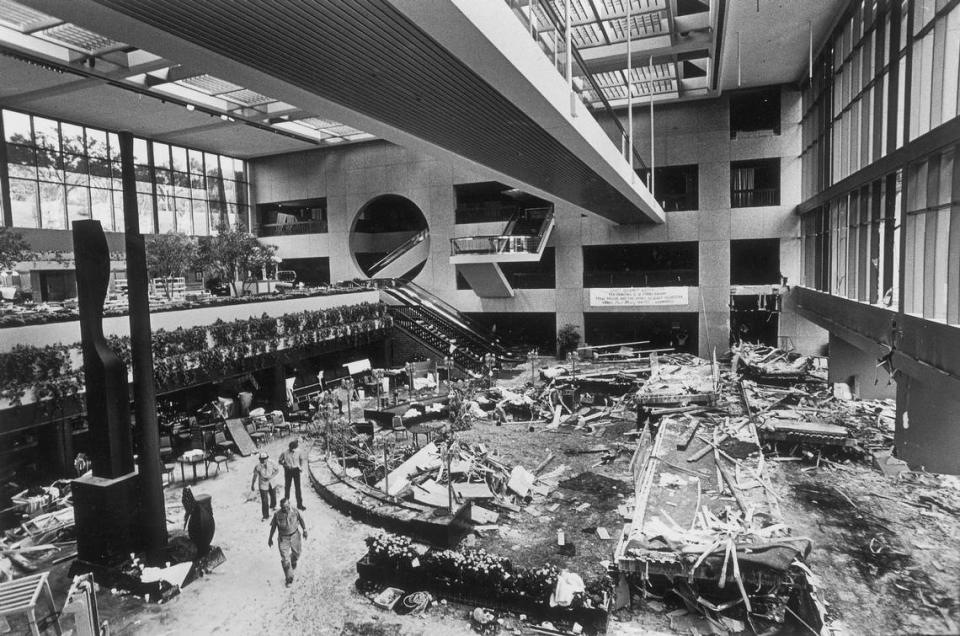 The wreckage of the second floor and third floor skywalks rests on the floor of the lobby of the Hyatt Regency Hotel after they came crashing to the floor killing 114 people who were there to dance. The square doorway where the upper skywalk was attached can be seen in the upper right and the second floor skywalk was two floors below that. The Third floor skywalk which did not have another skywalk attached to it remained intact.