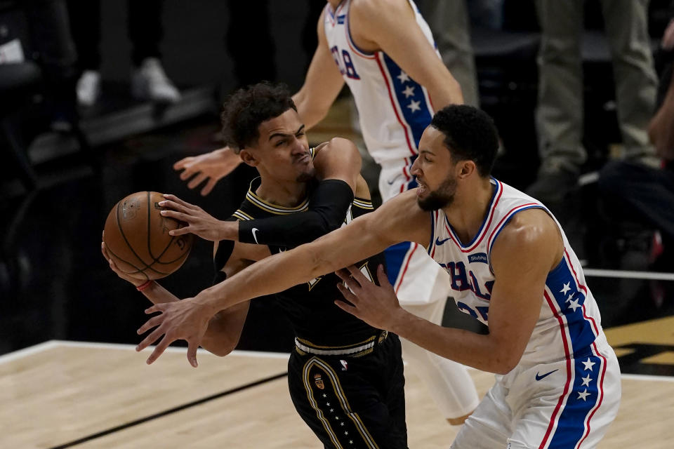 Atlanta Hawks guard Trae Young (11) is defended by Philadelphia 76ers guard Ben Simmons (25) as he looks for an opening during the first half of Game 6 of an NBA basketball Eastern Conference semifinal series Friday, June 18, 2021, in Atlanta. (AP Photo/John Bazemore)