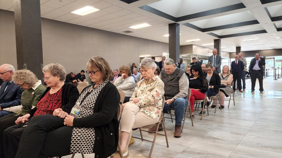 Attendees Tuesday at the Randall County Annex bow their heads in prayer during the naming ceremony of the building.