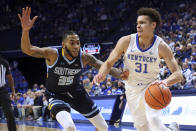 Kentucky's Kellan Grady (31) drives while defended by Southern University's Tyrone Lyons (35) during the first half of an NCAA college basketball game in Lexington, Ky., Tuesday, Dec. 7, 2021. (AP Photo/James Crisp)