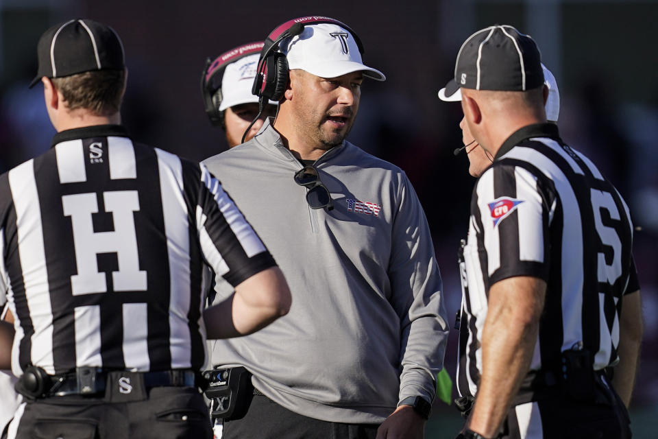 Troy head coach Jon Sumrall speaks with an official during the first half of an NCAA college football game against Louisiana-Lafayette , Saturday, Nov. 18, 2023, in Troy, Ala. (AP Photo/Mike Stewart)