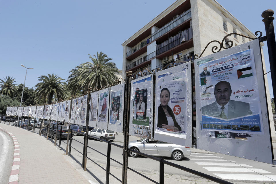 Electoral posters are pictured in Algiers, Wednesday, June 9, 2021. Algerians are preparing for the June 12 elections to elect members of parliament. (AP Photo/Toufik Doudou)