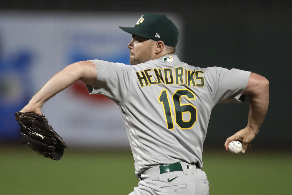 FILE - Oakland Athletics pitcher Liam Hendriks works against the San Francisco Giants in the 10th inning of a baseball game in San Francisco, in this Friday, Aug. 14, 2020, file photo. The Chicago White Sox have finalized a $54 million, three-year deal with Oakland Athletics closer Liam Hendriks, another big move as they set their sights on a championship run. The deal was announced Friday, Jan. 15, 2021. (AP Photo/Ben Margot, File)