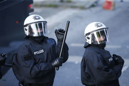 German riot police officers look on during demonstrations. REUTERS/Hannibal Hanschke