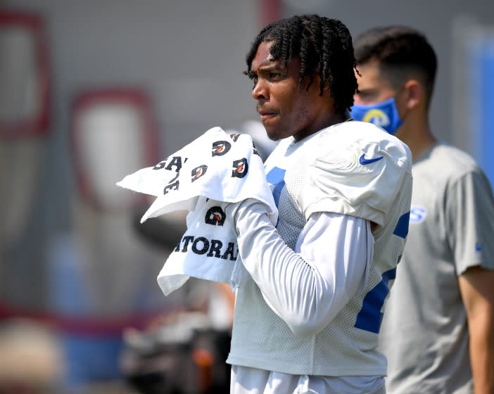 Rams cornerback Jalen Ramsey watches training camp practice from the sideline.